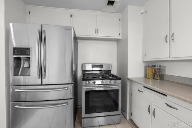 4454 Ute Dr, San Diego, CA 92117 - kitchen with appliances with stainless steel finishes, white cabinets, light countertops, and light tile patterned floors