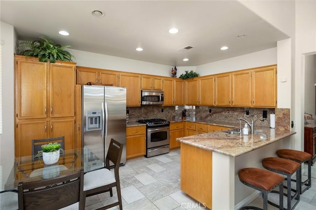 1581 Manor Ln, Glendora, CA 91741 - kitchen with stainless steel appliances, a peninsula, tasteful backsplash, light stone counters, and recessed lighting