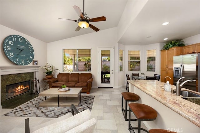1581 Manor Ln, Glendora, CA 91741 - living area featuring a high end fireplace, recessed lighting, ceiling fan, lofted ceiling, and light stone finish flooring