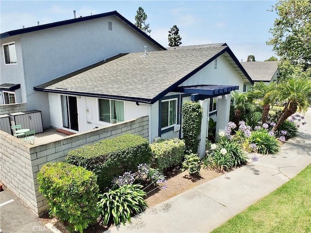 16573 Pescado Ln Unit 3A, Huntington Beach, CA 92649 - back of house featuring a shingled roof and stucco siding
