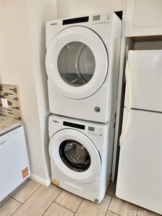 16573 Pescado Ln Unit 3A, Huntington Beach, CA 92649 - laundry area with estacked washer and dryer and baseboards