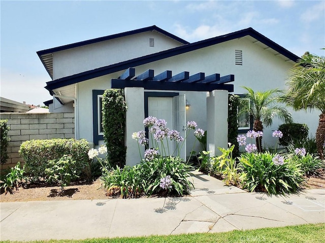 16573 Pescado Ln Unit 3A, Huntington Beach, CA 92649 - view of front facade featuring stucco siding and a pergola