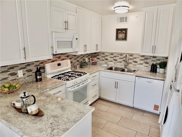 16573 Pescado Ln Unit 3A, Huntington Beach, CA 92649 - kitchen with white appliances, white cabinetry, tasteful backsplash, and light tile patterned floors