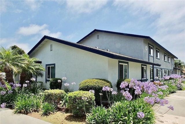 16573 Pescado Ln Unit 3A, Huntington Beach, CA 92649 - view of side of property featuring stucco siding