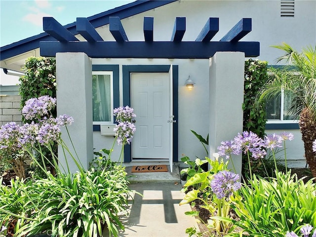 16573 Pescado Ln Unit 3A, Huntington Beach, CA 92649 - doorway to property with stucco siding