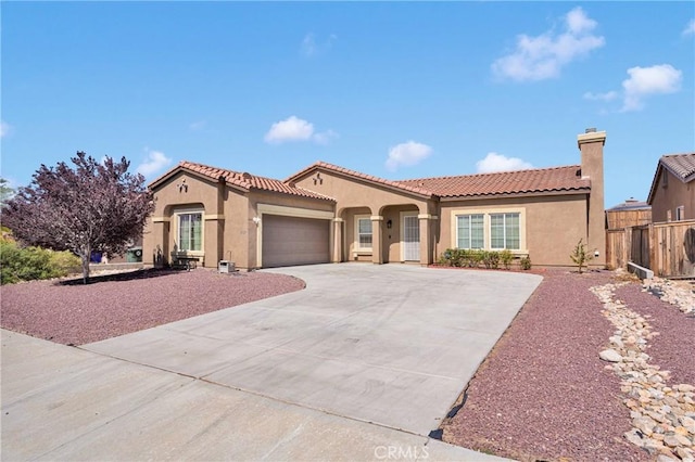 16029 Carmelia Dr, Victorville, CA 92394 - mediterranean / spanish-style house with stucco siding, a garage, concrete driveway, and a tile roof