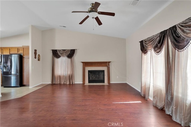 16029 Carmelia Dr, Victorville, CA 92394 - unfurnished living room with vaulted ceiling, wood finished floors, a fireplace with flush hearth, and a ceiling fan