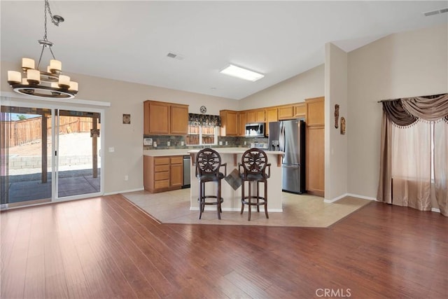 16029 Carmelia Dr, Victorville, CA 92394 - kitchen with stainless steel appliances, a chandelier, light countertops, a kitchen breakfast bar, and lofted ceiling