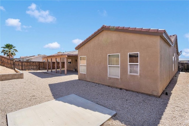 16029 Carmelia Dr, Victorville, CA 92394 - rear view of house with a patio area, a fenced backyard, and stucco siding