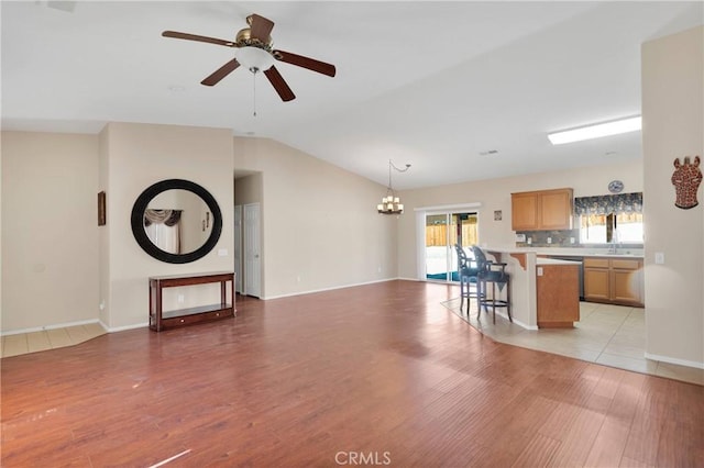 16029 Carmelia Dr, Victorville, CA 92394 - living room with vaulted ceiling, light wood-type flooring, a chandelier, and ceiling fan