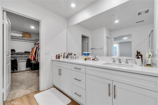 34410 Granite Rd, Yucaipa, CA 92399 - full bath with double vanity, wood finished floors, a walk in closet, and recessed lighting