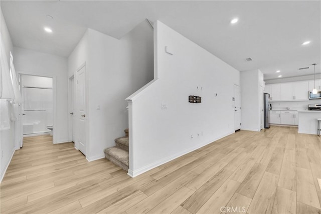 34410 Granite Rd, Yucaipa, CA 92399 - unfurnished living room featuring light wood-style flooring, stairs, and recessed lighting