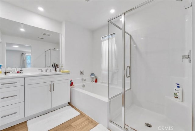 34410 Granite Rd, Yucaipa, CA 92399 - full bathroom with a shower stall, vanity, a bath, wood finished floors, and recessed lighting