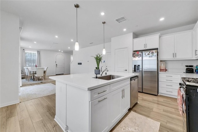 34410 Granite Rd, Yucaipa, CA 92399 - kitchen featuring stainless steel appliances, white cabinets, light wood finished floors, recessed lighting, and light countertops
