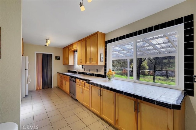 13001 Yuba Nevada Rd, Dobbins, CA 95935 - kitchen featuring freestanding refrigerator, dishwasher, backsplash, light tile patterned flooring, and tile countertops