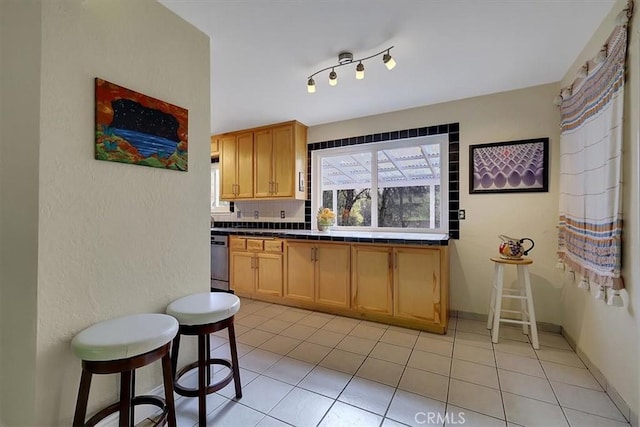13001 Yuba Nevada Rd, Dobbins, CA 95935 - kitchen featuring tile counters, light tile patterned floors, dishwasher, and backsplash