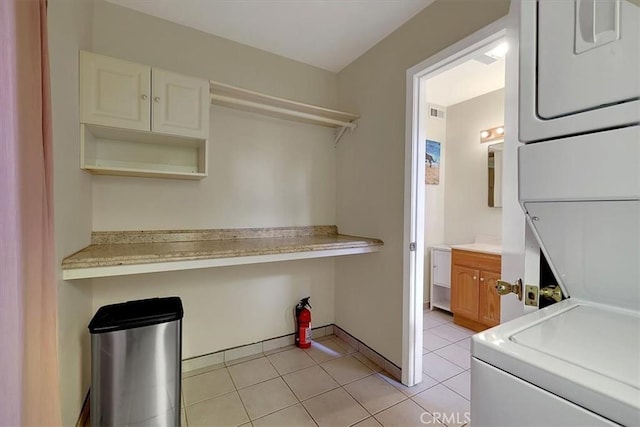 13001 Yuba Nevada Rd, Dobbins, CA 95935 - laundry area featuring stacked washer / drying machine and light tile patterned floors