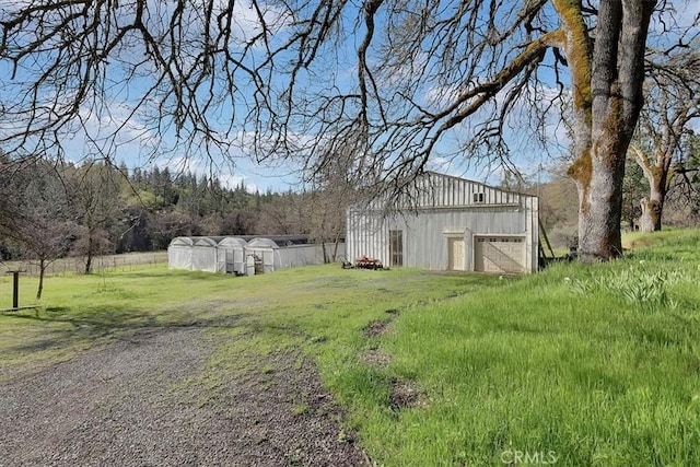 13001 Yuba Nevada Rd, Dobbins, CA 95935 - view of yard featuring an outdoor structure, an exterior structure, a garage, and driveway