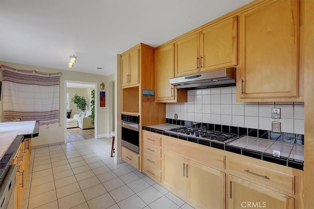 13001 Yuba Nevada Rd, Dobbins, CA 95935 - kitchen with stainless steel appliances, under cabinet range hood, tile counters, light tile patterned flooring, and decorative backsplash