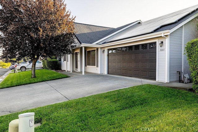 1085 Admiral Ln, Chico, CA 95973 - single story home with a front lawn, concrete driveway, a garage, solar panels, and a shingled roof