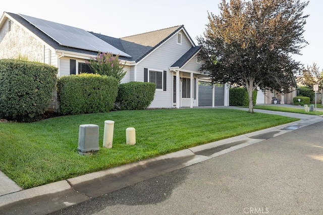 1085 Admiral Ln, Chico, CA 95973 - view of front of property with roof mounted solar panels, driveway, a front lawn, and a garage