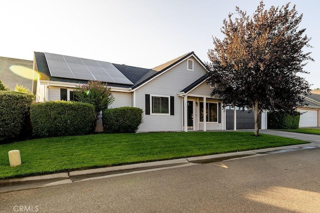 1085 Admiral Ln, Chico, CA 95973 - view of front facade featuring roof mounted solar panels, a front lawn, an attached garage, and driveway