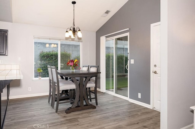 1085 Admiral Ln, Chico, CA 95973 - dining space featuring lofted ceiling, a chandelier, and wood finished floors