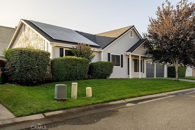 1085 Admiral Ln, Chico, CA 95973 - view of front of home with roof mounted solar panels, a front yard, concrete driveway, and a garage