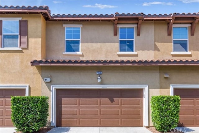 28606 Jardineras Dr, Valencia, CA 91354 - view of front facade with an attached garage, stucco siding, and driveway