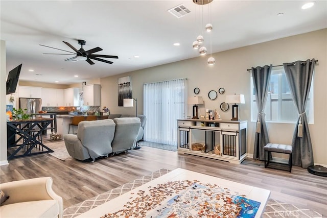 7002 Alice St, Highland, CA 92346 - living area with plenty of natural light, ceiling fan, light wood finished floors, and recessed lighting