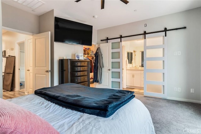 7002 Alice St, Highland, CA 92346 - carpeted bedroom with a barn door, a walk in closet, ensuite bathroom, a closet, and ceiling fan