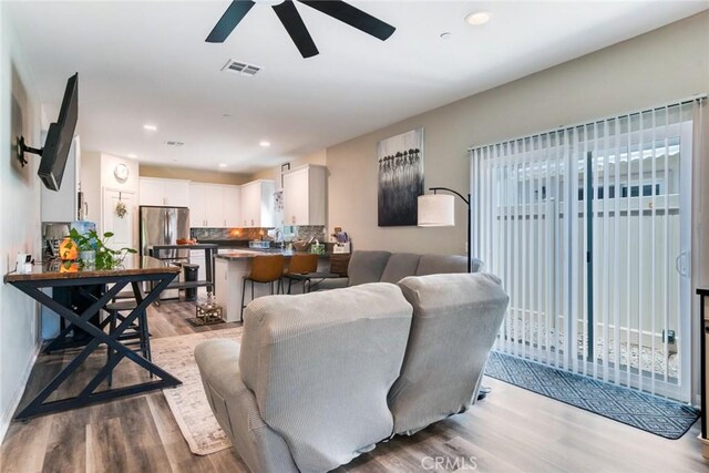 7002 Alice St, Highland, CA 92346 - living area with light wood-style flooring, a ceiling fan, recessed lighting, and healthy amount of natural light