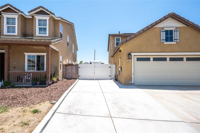 3094 Crooked Branch Way, San Jacinto, CA 92582 - view of property exterior with a gate, stucco siding, driveway, a tile roof, and covered porch