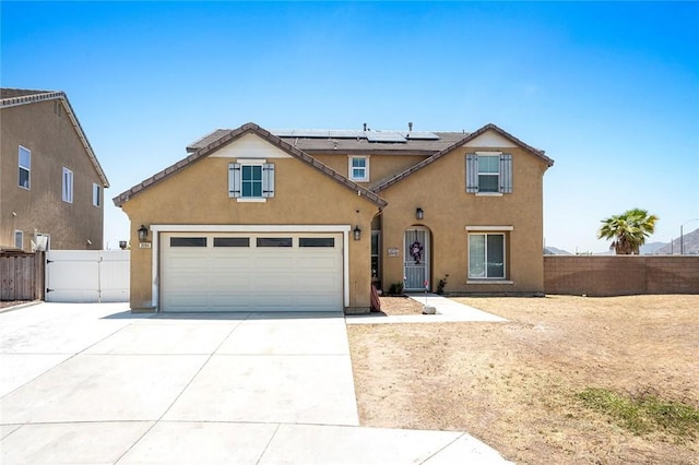 3094 Crooked Branch Way, San Jacinto, CA 92582 - traditional-style home with roof mounted solar panels, concrete driveway, stucco siding, a gate, and an attached garage
