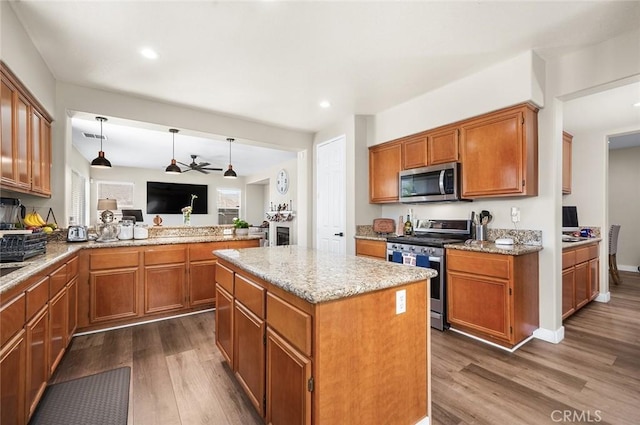 3094 Crooked Branch Way, San Jacinto, CA 92582 - kitchen with stainless steel appliances, dark wood-type flooring, ceiling fan, brown cabinets, and recessed lighting