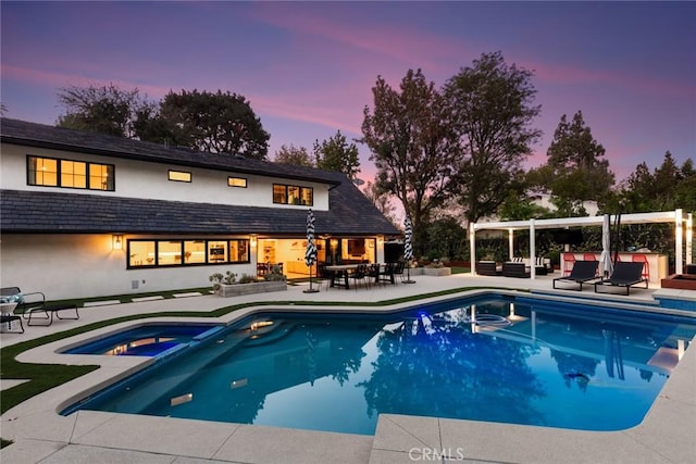 19258 Berclair Ln, Tarzana, CA 91356 - pool at dusk featuring a patio, an outdoor hangout area, and a pool with connected hot tub