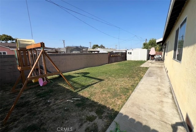 1019 W Arbutus St, Compton, CA 90220 - fenced backyard with a playground and a storage shed