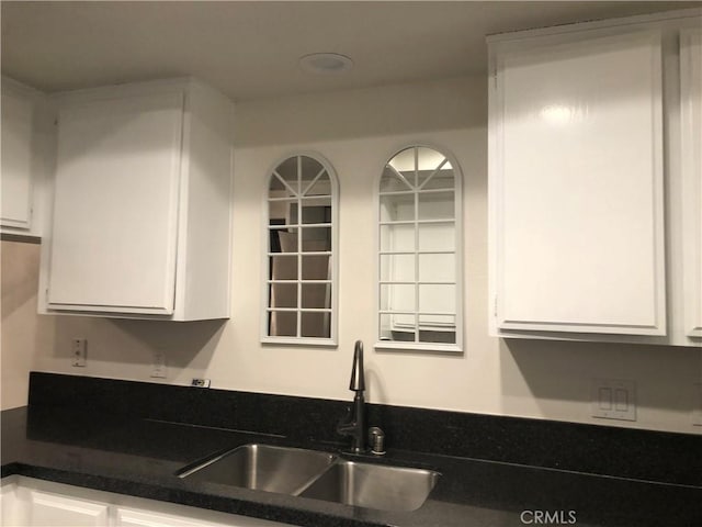 2545 Via Campesina Unit 102, Palos Verdes Estates, CA 90274 - kitchen with white cabinets and dark countertops