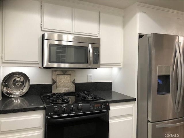 2545 Via Campesina Unit 102, Palos Verdes Estates, CA 90274 - kitchen with appliances with stainless steel finishes, white cabinetry, and dark stone counters