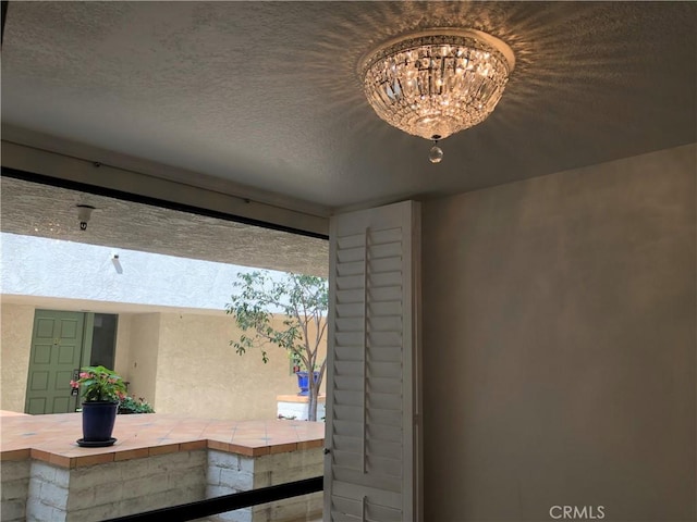 2545 Via Campesina Unit 102, Palos Verdes Estates, CA 90274 - detailed view of stucco siding and a chandelier