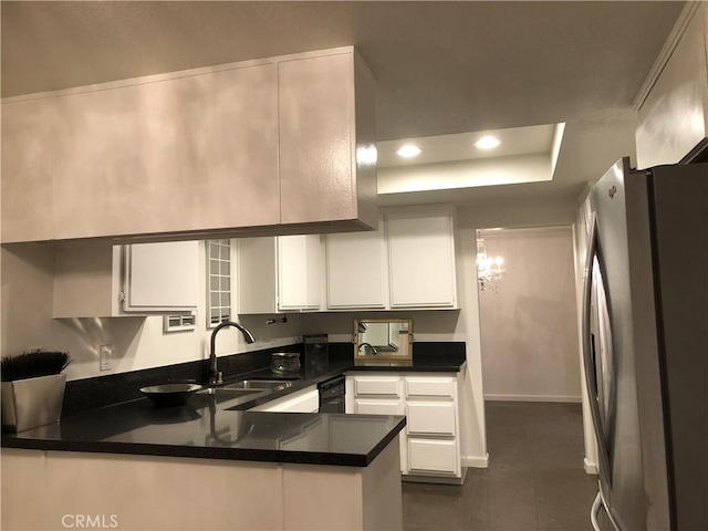 2545 Via Campesina Unit 102, Palos Verdes Estates, CA 90274 - kitchen featuring freestanding refrigerator, a peninsula, white cabinetry, dark countertops, and a raised ceiling