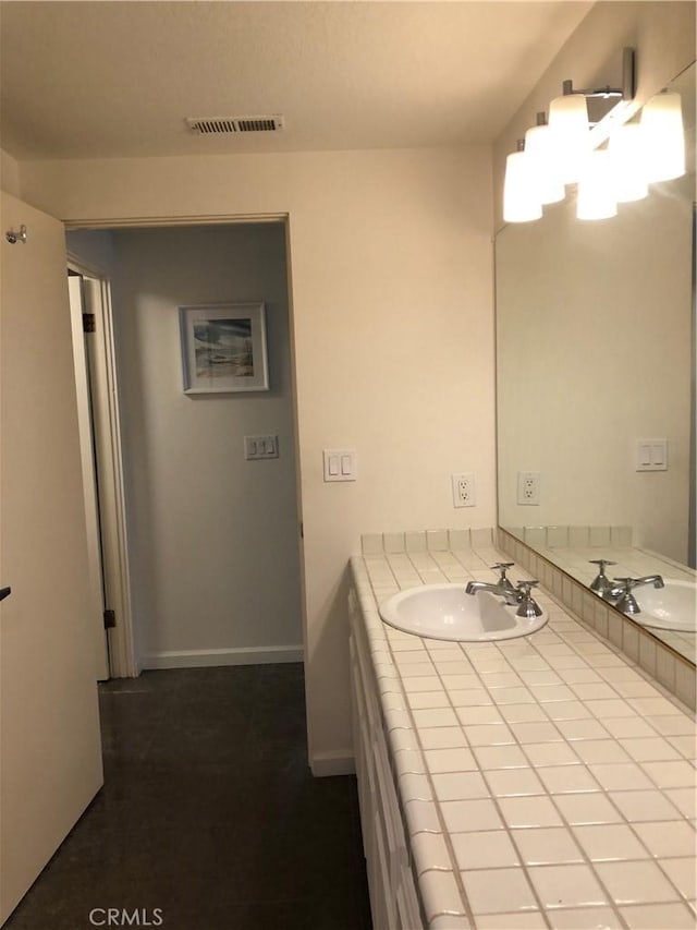 2545 Via Campesina Unit 102, Palos Verdes Estates, CA 90274 - bathroom with double vanity and baseboards