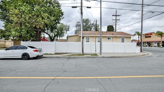 9051 Walker St, Cypress, CA 90630 - view of asphalt street featuring street lighting, sidewalks, and curbs