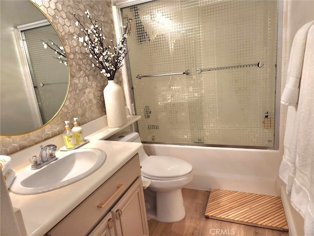 26523 Starling Ct, Canyon Country, CA 91387 - full bathroom with wood finished floors, vanity, and bath / shower combo with glass door