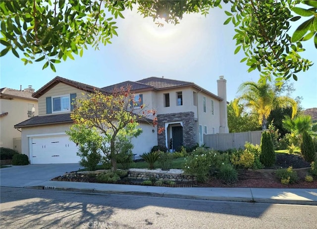 26523 Starling Ct, Canyon Country, CA 91387 - view of front of home with stone siding, a garage, driveway, and stucco siding
