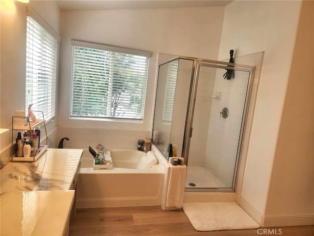26523 Starling Ct, Canyon Country, CA 91387 - full bathroom with a bath, wood finished floors, and a shower stall