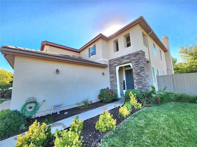 26523 Starling Ct, Canyon Country, CA 91387 - view of front of home featuring stone siding, stucco siding, and a chimney
