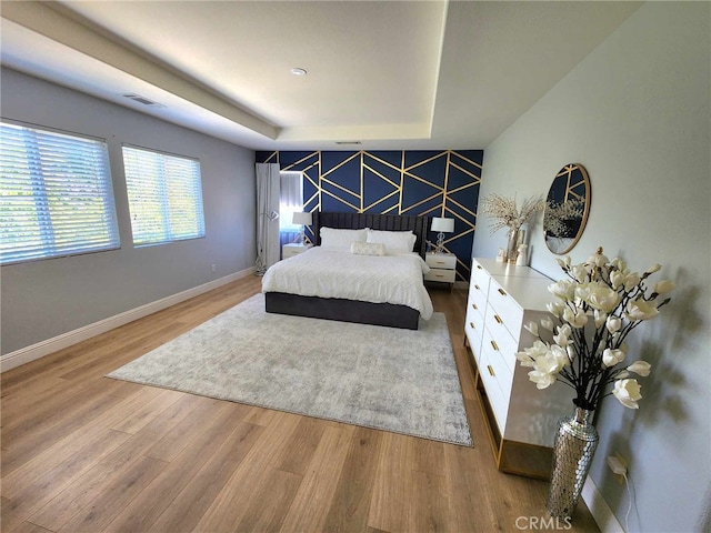 26523 Starling Ct, Canyon Country, CA 91387 - bedroom featuring wood finished floors, an accent wall, and a raised ceiling