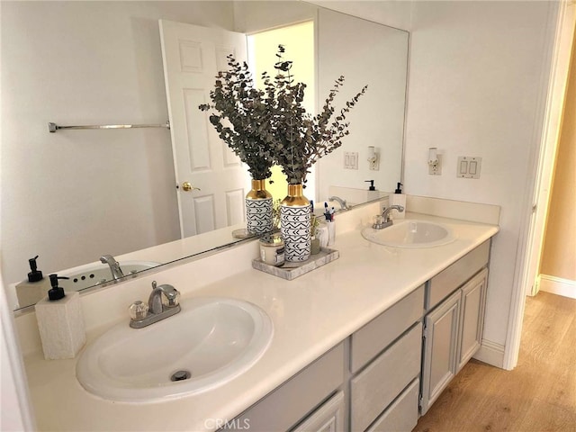26523 Starling Ct, Canyon Country, CA 91387 - bathroom featuring wood finished floors and double vanity
