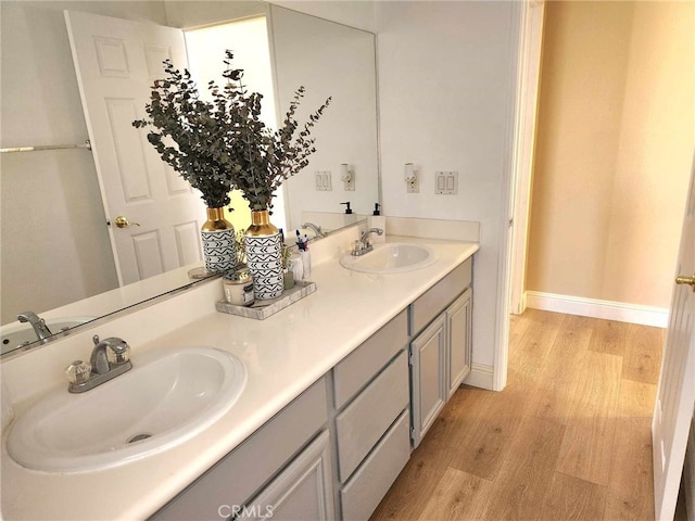 26523 Starling Ct, Canyon Country, CA 91387 - bathroom with wood finished floors and double vanity
